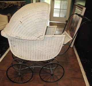 ANTIQUE WICKER BABY CARRIAGE Antique Wicker Baby Carriage. Circa 1900. Measures 41" tall x 40" wide x 20" deep. Overall condition is good to fair. Wear consistent with age and use. Some losses to wicker (see close-up photos). Starting Bid $20. Auction Estimate $50 - $80.   