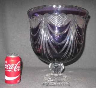 AMETHYST CUT CRYSTAL FOOTED BOWL Large, Amethyst Cut to Clear, Crystal Footed Bowl. Measures 12-1/2" tall x 8-3/4" wide. Condition is Excellent. Mint. No damage. Starting Bid $150. Auction Estimate $250 - $350.    