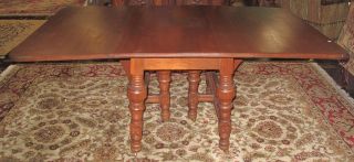 ANTIQUE EASTLAKE WALNUT DROP LEAF DINING TABLE Antique Eastlake Walnut Drop Leaf Dining Table. Measures 29-1/2" tall x 70" wide, when opened and 40" deep. Measures 27" wide with leaves down. Condition is good. No damage. 