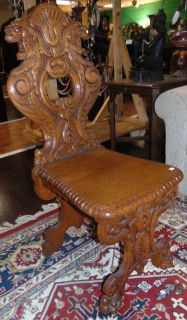 ANTIQUE ITALIAN CARVED OAK SGABELLO CHAIR Antique Italian Carved Oak Sgabello Chair. A Sgabello is a type of chair or stool typical of the Italian Renaissance. Measures 42-1/2" tall x 18" wide x 22" deep. Condition is very good with minimal wear. 1 small chip on back side (see close-up photo). 