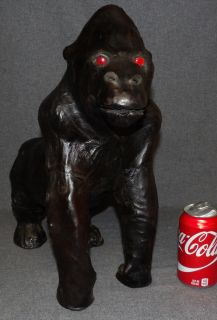 HANDMADE LEATHER GORILLA SCULPTURE Handmade Leather Gorilla Sculpture with Red Glass Eyes. Measures 17" tall x 8" wide x 15" deep. Condition is Very good. No damage. Starting Bid $50. Auction Estimate $150 - $300. 