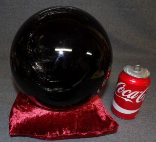 200mm BLACK OBSIDIAN CRYSTAL BALL 200mm Black Sheen Obsidian Crystal Ball or Sphere on a Red Velvet Bean Bag. Measures 8" round. Condition is Excellent. Mint. No damage. Starting Bid $250. Auction Estimate $500 - $600.  