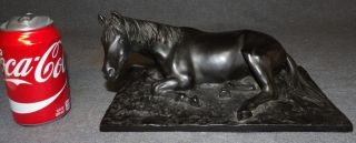 VINTAGE BRONZE RECLINING HORSE SCULPTURE Vintage Bronze Reclining Horse Sculpture. Measures 5" tall x 11-1/4" wide x 6-1/2" deep. Unsigned. Condition is good. Some wear to finish. No damage. Starting Bid $100. Auction Estimate $250 - $400.  