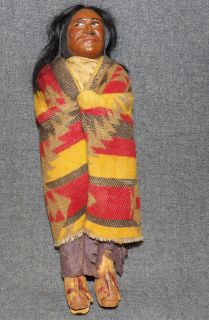 VINTAGE NATIVE AMERICAN SKOOKUM DOLL 10-1/2" Vintage Native American Skookum Doll. Measures 10-1/2" tall. Condition is good. Some Wear. Starting Bid $30. Auction Estimate $60 - $120.    