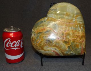LARGE, CARVED & POLISHED GREEN CALCITE HEART Large, Carved & Polished Green Calcite Heart. Includes wire stand. Measures 9" tall x 9" wide x 2-1/2" deep. Condition is Excellent. Mint. No damage. Starting Bid $100. Auction Estimate $200 - $250.