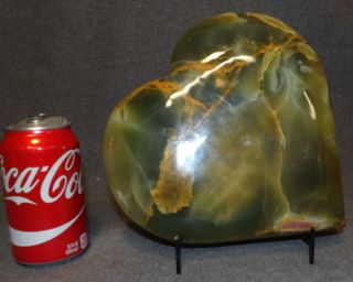LARGE, CARVED & POLISHED GREEN CALCITE HEART Large, Carved & Polished Green Calcite Heart. Includes wire stand. Measures 9" tall x 9" wide x 2-1/2" deep. Condition is Excellent. Mint. No damage. Starting Bid $100. Auction Estimate $200 - $250.   