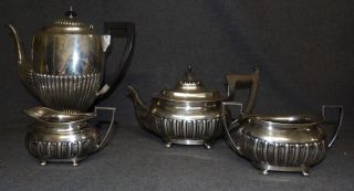 VINTAGE 4 pc. WALKER & HALL SHEFFIELD STERLING COFFEE SET Vintage 4 piece Sterling Silver Coffee Set by Walker & Hall Sheffield. Includes: 11" Coffee Pot, 6-1/2" Hot Water Pot, Creamer & Sugar. Coffee Pot is monogrammed. Overall condition is very good. No damage. Starting Bid $2,000. Auction Estimate $2,500 - $3,000.   