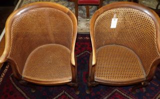 PAIR of ANTIQUE CANE BACK ARMCHAIRS Pair of Antique Cane Back Armchairs. Each measure 34" tall x 22" wide x 21" deep. Overall condition is good. Minimal wear to finish. Starting Bid $100. Auction Estimate $150 - $250.   