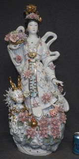 LARGE PORCELAIN GEISHA GODDESS WITH FLOWERS Large Porcelain Geisha Goddess with Flowers. Measures 36" tall x 17" wide x 9" deep. Condition is very good. No damage. Starting Bid $300. Auction Estimate $500 - $800.    