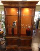 4 DOOR DISPLAY CABINET Tall 4 Door Display Cabinet. Silk lined Display with glass shelves. Measures 97" tall x 57" wide x 16" deep. Overall condition is good. Starting Bid $40. Auction Estimate $350 - $500.   