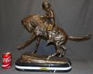 BRONZE COWBOY after FREDERIC REMINGTON Western Bronze Sculpture "Cowboy" after Frederic Remington on a Triple Marble Base. Signed. Measures 22" tall x 25" wide x 8-1/2" deep. Overall condition is Excellent. No Damage. Starting Bid $450. Auction Estimate $600 - $750.